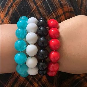 Four different colored beaded bracelets